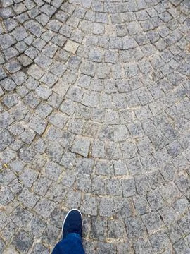 Foot on a paved floor Stock Photos