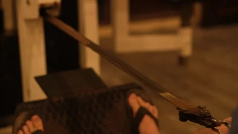 Foot on Rowing Machine During Indoor Workout Session at an Evening Fitness Video stock 312265314