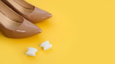 Foot silicone toe separator and beige shoes. Valgus on female feet Stock Photos