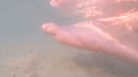 Foot step in sand stirring up mud ground underwater in lake Stock Footage 115529746