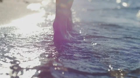 Foot stepping on the sea Stock Footage