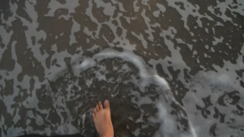 Foot steps into shallow ocean waves Stock Footage 337981467