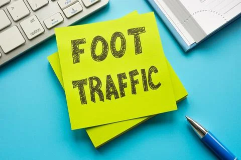 Foot traffic concept. A stack of sticky notes and a keyboard. Stock Photos