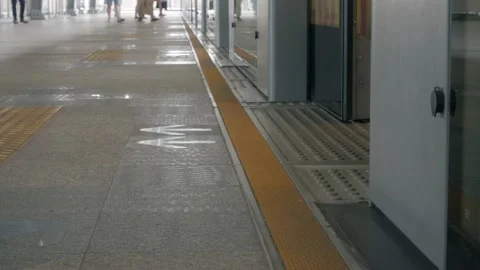 Foot View on platform of train station while train cimmuter arrive to platfor Stock Footage 206779976