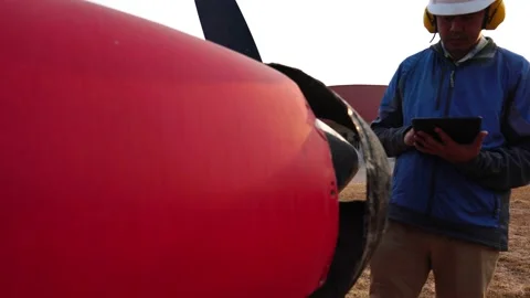 Footage 4K: Male engineer using digital tablet with a small plane Stock Footage 147144119