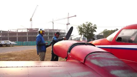 Footage 4K: Mechanics working on a small aircraft  Stock-Footage 147143617