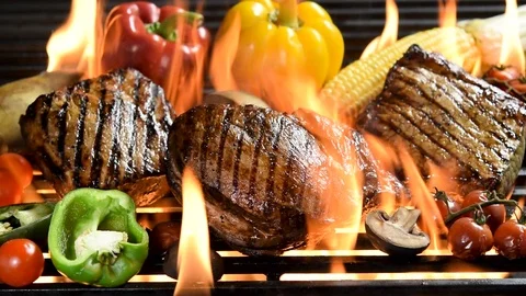Footage of assorted grilled meat with vegetable on the flaming grill . Видео 126422990