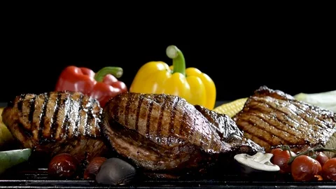 Footage of assorted grilled meat with vegetable on the flaming grill . Stock Footage 126955768