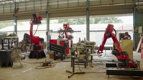 Footage in the background of a robotic arm inside the factory. Stock Footage 194963794