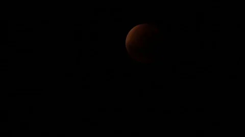 Footage of blood moon timelapse in a dark sky Stock Footage 90021980