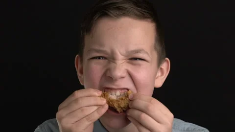 Footage boy eats chicken wings or nuggets, fast food Stock Footage 102742313