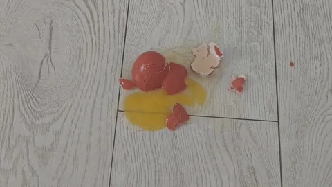 Footage capturing a red Easter egg falling in slow motion before shattering Stock Footage 343122656