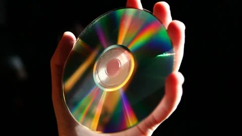 Footage of cd disk hand dark background Stock Footage 170305192