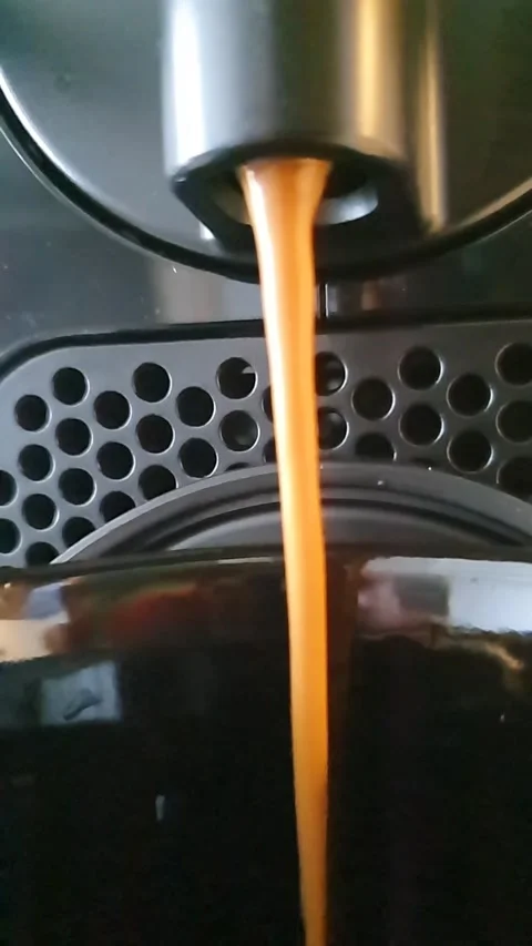 Footage close up of coffee machine pouring coffee into the cup Stock Footage 187094412