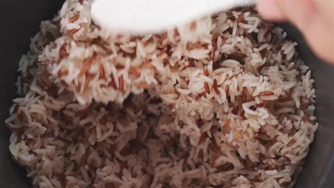 Footage Close up Hand Using White Ladle Scooping Hot Mixed Brown and Jasmin.. Video stock 326052795
