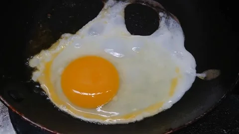 Footage close up, top view Frying Sunny Side Egg Stock Footage 220105399