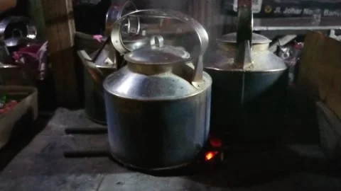 Footage, close up water boiling using charcoal at old aluminium kettle Stock Footage 229749126