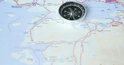 Footage of a compass going crazy while lying on a road map showing Istanbul Stock Footage 55328419
