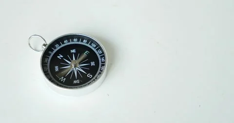 Footage of a compass lying on a table and goes crazy Stock Footage 55328469