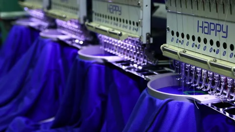Footage of Computerized embroidery machine in progress embroidery logo on T-s Stock Footage 145633899
