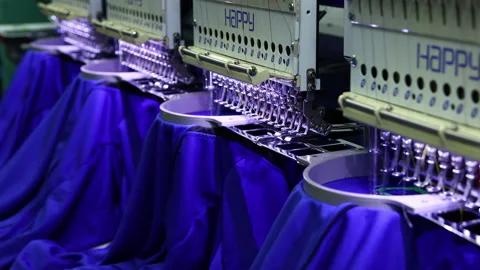 Footage of Computerized embroidery machine in progress embroidery logo on T-s Stock Footage 145634060