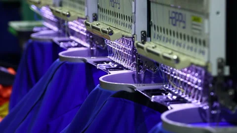 Footage of Computerized embroidery machine in progress embroidery logo on T-s Stock Footage 145635772
