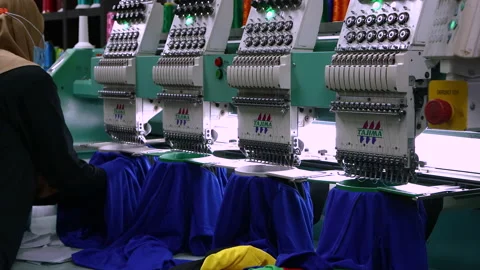Footage of Computerized embroidery machine in progress embroidery logo on T-s Stock Footage 145637166
