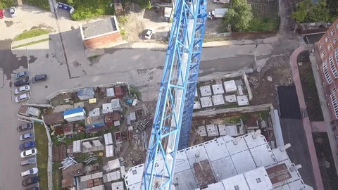 Footage a construction site with a blue crane running at a height on a multi- Stock Footage 94486232