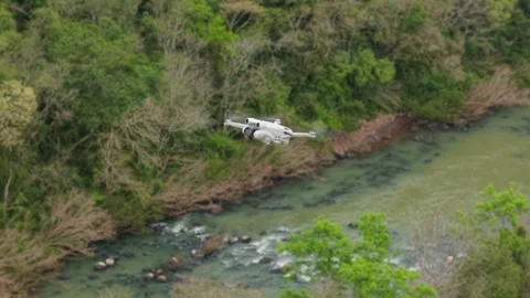 Footage of a drone flying over a river. DJI. Mini 3 Pro. Stock Footage 317658015