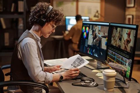 Footage editor examining script at workplace 写真素材