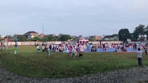 The footage of Eid Mubarak pray in the sport center field Stock Footage 239123647
