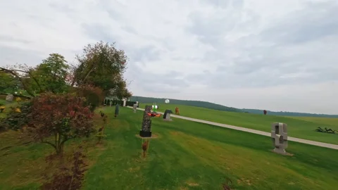Footage of fast drone FPV flight over cinematic park with modern sculpture, art Stock Footage 186124206