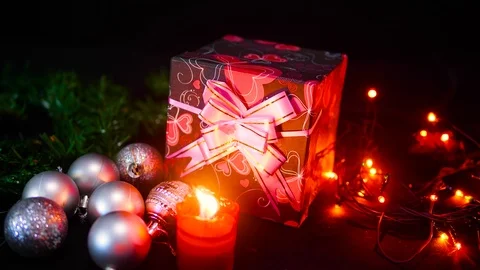 Footage of gift boxes, candle burning and lamp twinkling. Christmas day Stock Footage 100246217