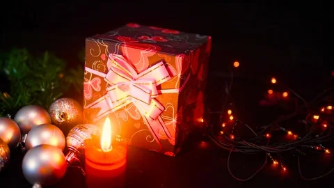 Footage of gift boxes, candle burning and lamp twinkling. Christmas day Stock Footage 100246370
