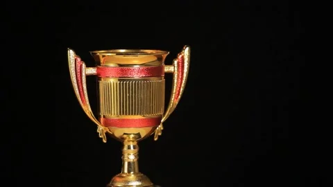 Footage of gold cup dark background Stock Footage 149351819