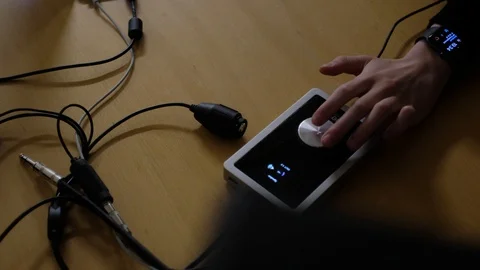 A footage of Guy adjusting audio with Apogee Duet audio interface! Stock Footage 99467331