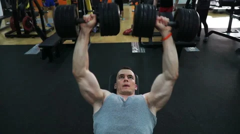 Footage guy doing exercise dumbbell bench press at the gym Видео 62892982
