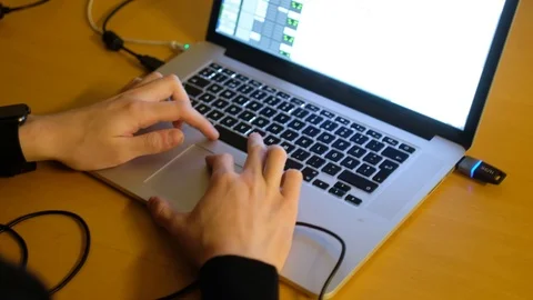 A footage of Guy using MacBook Pro! Scrolling with trackpad! Stock Footage 99467271