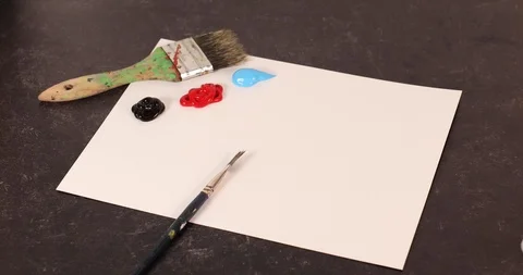 Footage of hand picking up paint brush painting the word art Stock Footage 126126577