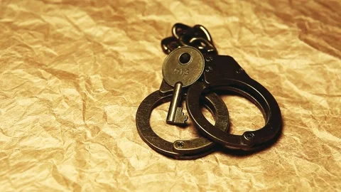 Footage of handcuffs paper background Stock Footage 287728751