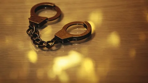 Footage of handcuffs table background Stock Footage 128826230