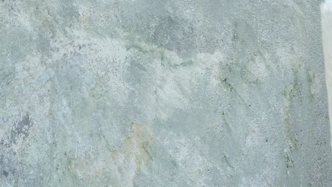 Footage of handheld paint roller brush with white color on cement background Stock Footage 122930398