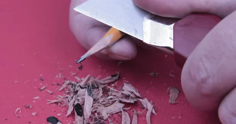 Footage of hands sharpening a pencil with a sharp knife Stock Footage 123020786