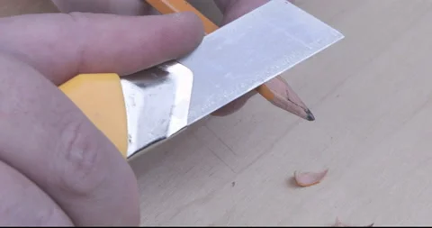Footage of hands sharpening a pencil with a sharp knife Stock Footage 123024852