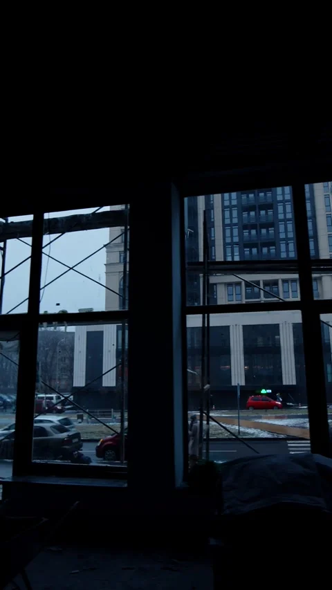 Footage from inside the dark interior of the unfinished building. Builders work Stock Footage 337717392