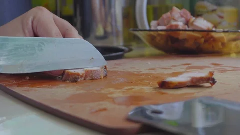 Footage of Lady hand using knife to slices Char Siew Meat on Chopping board. Stock Footage 129674799