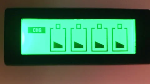 Footage of the lcd screen of charging device indicating batteries charging .. Stock Footage 300478248