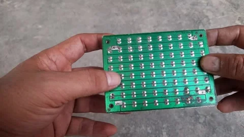 Footage of led lights arranged on a pcb and turned back and forth by someone' Stock Footage 250623803