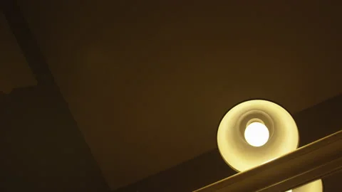 Footage of a Light Bulb Flickering Above a Staircase in an Abandoned House Stock Footage 208755460