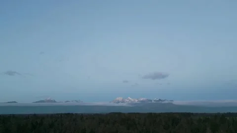 Footage made with a drone moving backwards filming snow covered mountains a.. Stock Footage 239769258